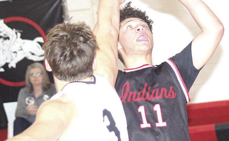 P.C.’s Darius Andersen (#11, right) goes up for a bucket underneath in Saturday consolation action. Paula Jasa/Republican
