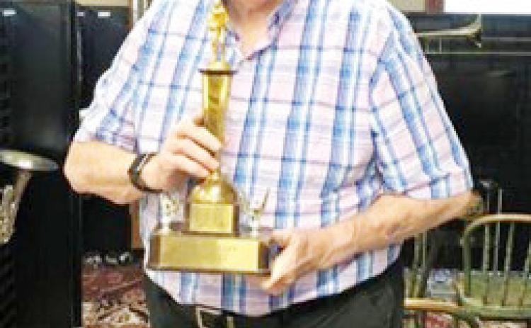 Russel Workman graduated from Table Rock in 1959 and returned to teach there in 1983. Here he is with a basketball trophy won when he was a senior. Although a high school athlete, music was his passion. He says he tells his grandchildren, “Real men sing!”