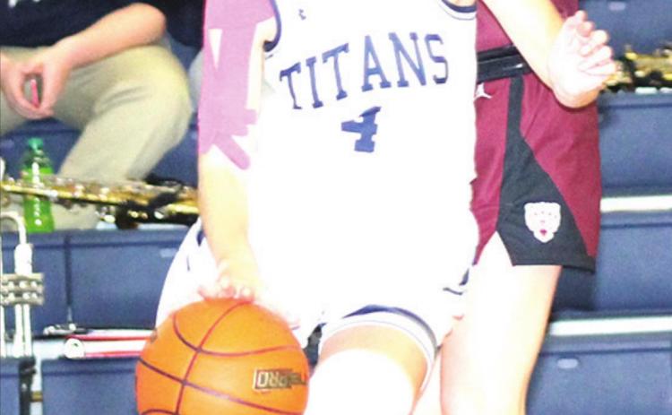 Paula Jasa/Republican HTRS’ Gracie Shafer (#4) drives the baseline against LHS’ Carleigh Weyers in Tuesday night’s game.