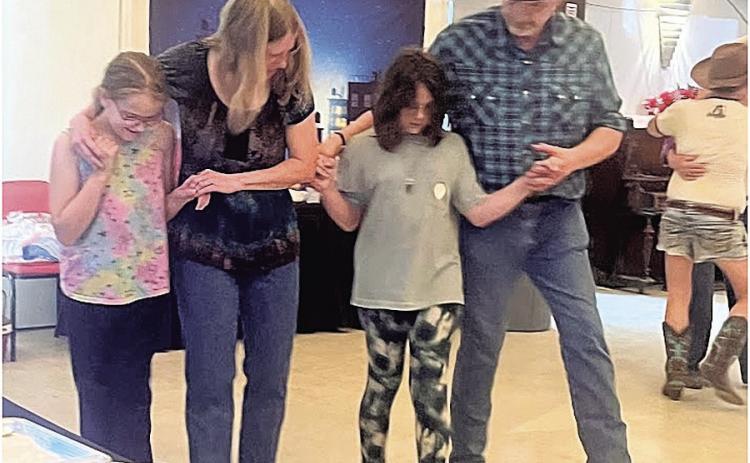 Learning the dance – Savannah Weimers and Lulu Evans of Table Rock taken under the wing of experienced dancers