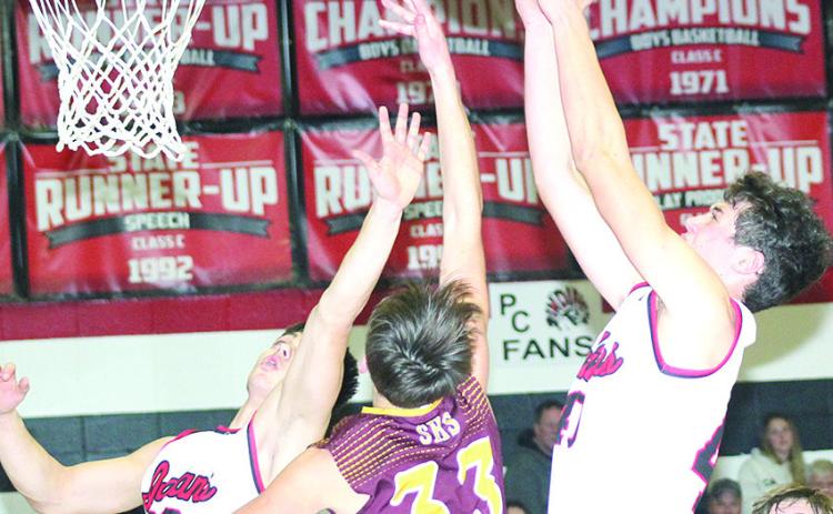 P.C.’s Oscar Machini (#40, right) and Anthony Kling (#23, left) go up for a rebound against Sterling in Friday night’s 59-29 victory over the Jets. Paula Jasa/Republican