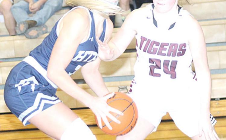 HTRS’ Katilyn Glathar (#3, left) goes up for a shot under the bucket against LHS’ Carleigh Weyers (#24, right). Glathar scored a single game school record of 32 points in the game against Lewiston last week. Paula Jasa/Republican