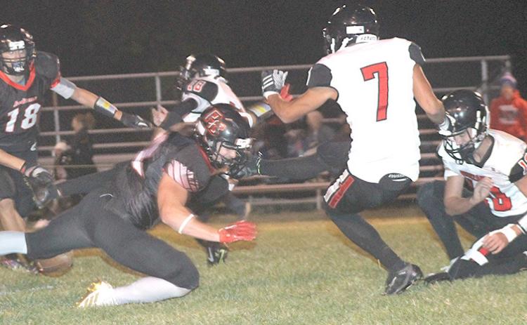 P.C.’s Andy Maloley (left) blocks a field goal attempt by Meridian in the first half. Paula Jasa/Republican