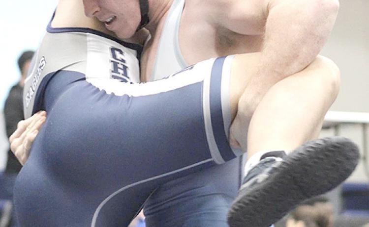 HTRS/P.C.’s Andy Maloley (above, right) picks up his opponent and gets ready to put him down while teammate Ty Faulks (left) goes for a pin on Saturday. photos provided by Jamie Maloley
