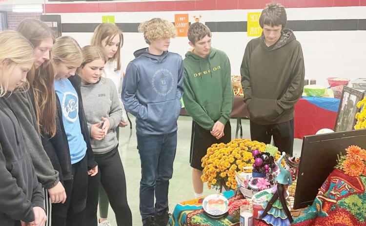 Members of the Spanish class look over the altar prepared for the Day of Dead celebration at Pawnee City High School. From left: Kennadie Benson, Hallye Friedly, Madison Fender, Emma Meints, Ariana Fetherkile, Jackson Glass, Zachary Wenzl, Hunter Johnson