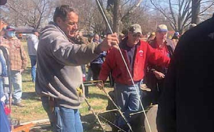 Volunteer Fire Fighter Rick Hunzeker marks an item as the auctioneer works his magic