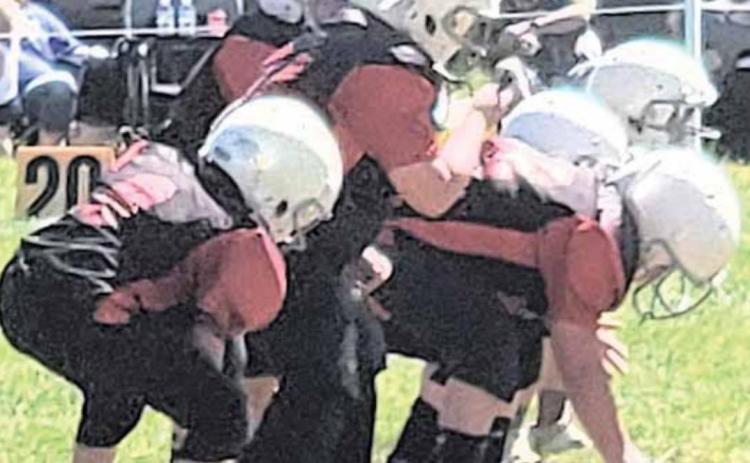 VICTORY FORMATION - The Pawnee City Peewee Football team prepares to take a knee in their game.