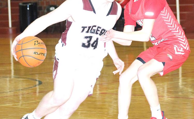 Lewiston’s Hayden Christen drives the lane against Johnson-Brock on Saturday. Christen led the Tigers with 15 points in the game. Paula Jasa/Republican
