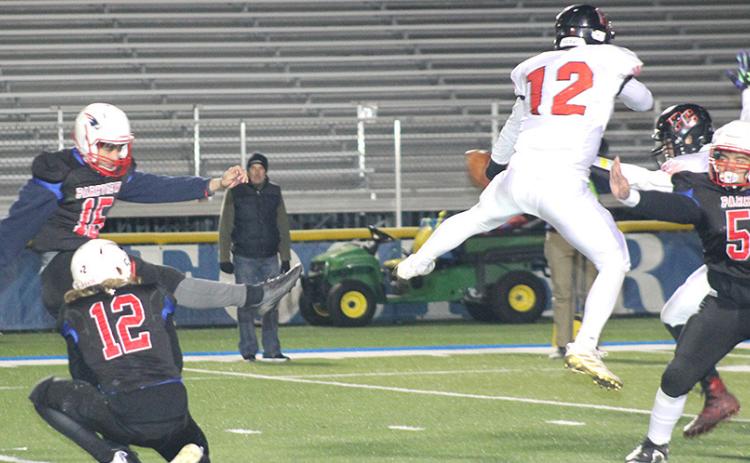 Pawnee City’s Andy Maloley (#12, center) blocks a PAT kick late in the game against Parkview Christian. Paula Jasa/Republican