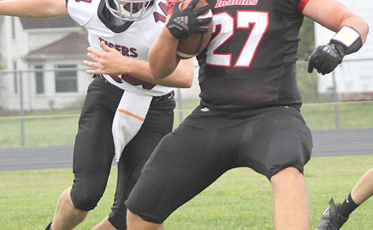 P.C.’s Joey Marteney (#27, right) swivels past LHS’ Caleb Rule (#14, left) on his way to score a touchdown. Paula Jasa/Republican