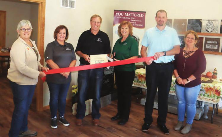 River Valley Memorials in Pawnee City had its Grand Opening Friday. Attending the ribbon cutting were from left Gail Howard, Cindy DeFreece, owners Bill and Mary Lyn Kruger, Chamber of Commerce President Brian Rottinghaus and City Clerk Tammy Curtis.