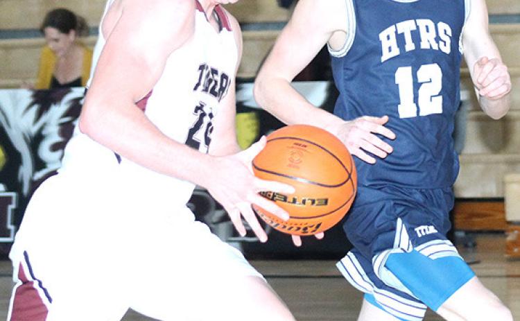 LHS’ Tristen Ray (#24, left) takes off down the floor while HTRS’ Brogan Dunlap (#12, right) defends. HTRS defeated LHS in a close 52-45 game last Tuesday night. Paula Jasa/Republican
