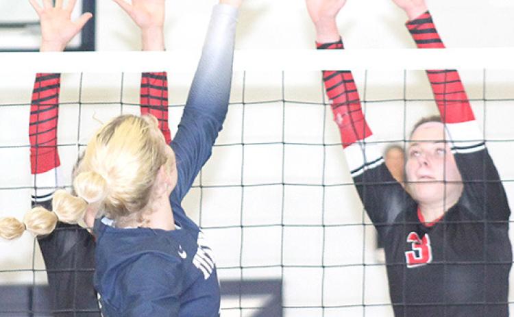 HTRS’ Elie Bstandig (center) goes up and over the Lady Mustang defense on Thursday. Bstandig had 13 kills, 2 solo ace blocks and 1 assisted block at the net. Paula Jasa/Republican