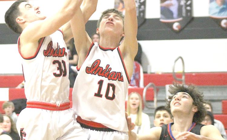 P.C.’s Jett Farwell (#30 left) and Drew Menninga (#10, right) battle for a rebound against Palmyra last Thursday night. Paula Jasa/Republican