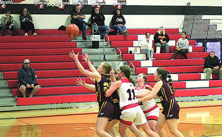 Members of the Junior Varsity Pawnee City Indians and Sterling Jets teams reach for the ball as it falls from the hoop