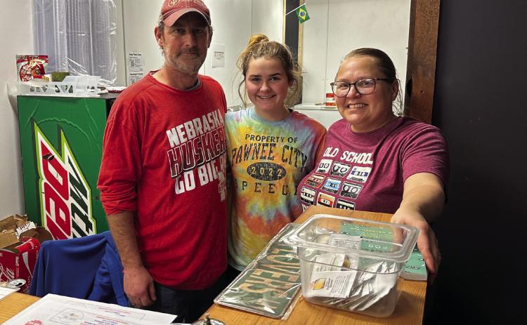 It’s a family affair! Arlan and Bobbie Meints take a break after the dinner rush at The Shop with their oldest daughter, Emma. All three of their daughters help with the restaurant and food truck when their school schedules allow.