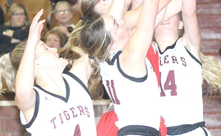 LHS’ Emma deKoning (#4, left) Carleigh Weyers (#11, center) and (Meagan Sanders (#14, right) battle a Meridian player for a rebound early in the Class B Girls’ Mudecas Championship game. LHS had a tough start and lost the game by a 25-41 score. Paula Jasa/Republican