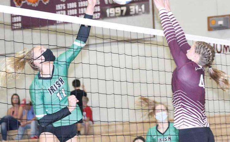 LHS’ Emma deKoning (#4, right) goes up for an ace block against Falls City Sacred Heart in Thursday night action. LHS lost the match in three sets. Paula Jasa/Republican