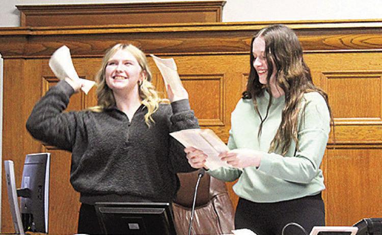Adilyn Nincehelser (left) and Lexus Tichy (right) tear up Judge Gaertig’s books in their dramatization of “criminal mischief”