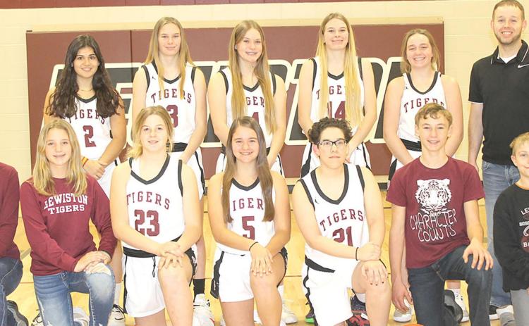 Members of the 2021-22 Lewiston Girls’ Basketball Team are front, from left: Maddie Janssen, s.m., Justice Currie, s.m., DeLanye Currie, Leah Christen, Delia Quintana, Payton Heideman, s.m., Evan Christen, s.m. Back row: Nayla Alos, Katelyn Sanders, Emma deKoning, Meagan Sanders, Carleigh Weyers, Head Coach Kyle Asche. Not pictured: Asst. Coach Alex Callan.