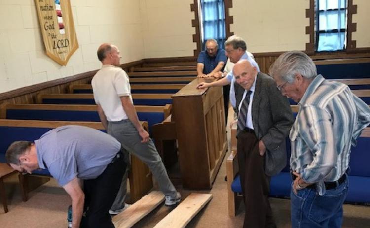 You can see the congregation relocating the piano to prepare the church for the meetings. you can see the custom made ramps they used to get the piano up the steps. It was facsinating to watch the farmers knowhow and muscle to get-r-done.