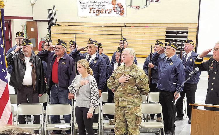 Veterans lead the Pledge of Allegiance during the Veteran's Day program at Lewiston School