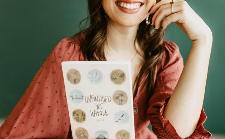 Reyana Tegtmeier with her book of poetry.