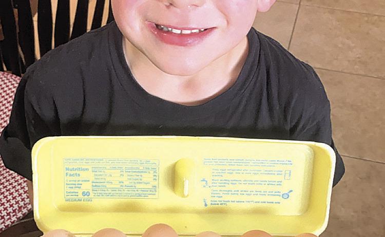 Above: Blane Vogt, age 5, with some of his Tall Corn Acres eggs