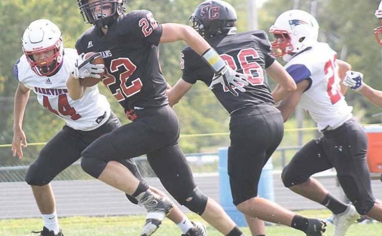 Pawnee City’s Kyle Gyhra (#22) scores the first touchdown of the game as teammate Bryce Gyhra (#26) helps pave the way. Paula Jasa/Republican