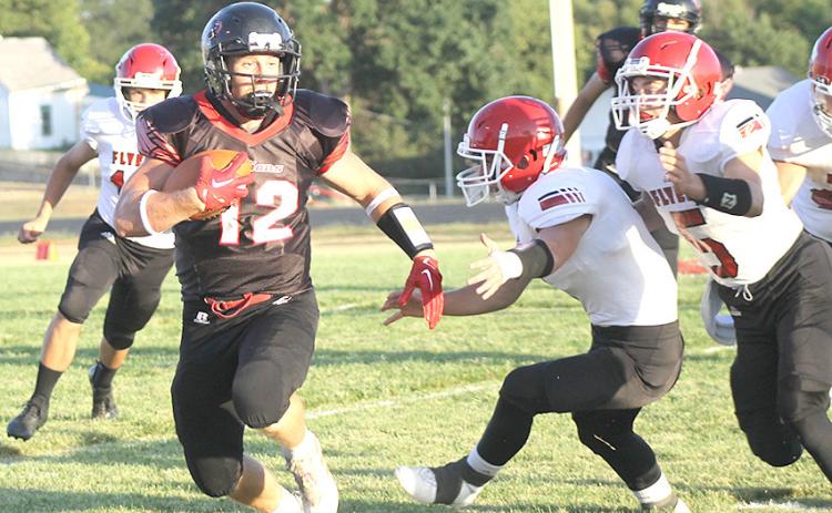 Pawnee City’s Andy Maloley (#12, left) eludes several Franklin tacklers on his way for a big gain in the first half. Pawnee City won their home opener easily, 48-7. Paula Jasa/Republican