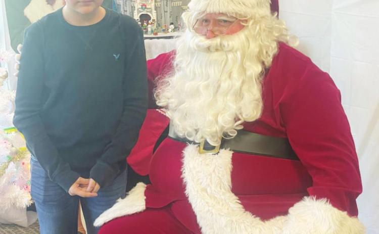 Ray Kappel/Republican Derrick Porter visited Santa at the Pawnee City Public Library Saturday.