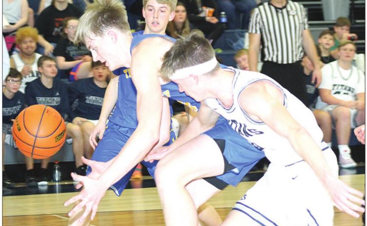 HTRS’ Hunter Frey (right) knocks away a pass down on the baseline during the Tri-County game last Tuesday. Frey had 2 steals in the game. Paula Jasa/Republican