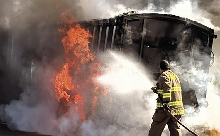 Pawnee City volunteer firefighter Colt Johnson sprays water on the blaze Photo courtesy of Laura Poskochil