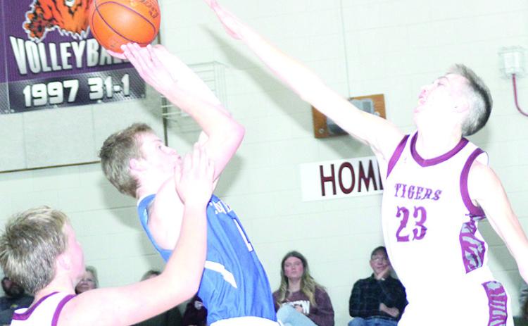 LHS’ Ashton Sanders (#23, right) and Caleb Rule (left) defend against a Cornerstone Christian player in the lane on Friday night. Lewiston lost a close game, 54-59. Paula Jasa/Republican
