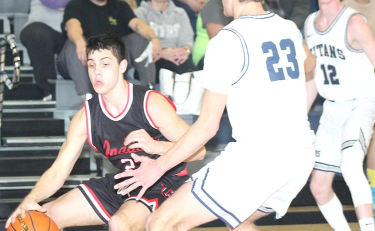 P.C.’s Anthony Kling (left) drives the baseline against HTRS’ Brandt Leech (#23, right) and also pictured is Brogan Dunlap (#12). Kling scored 27 points against HTRS. Paula Jasa/Republican