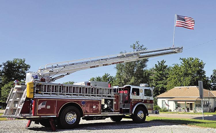 Pawnee City Firetruck hoists the American Flag on September 11th as we remember the lives lost. Photo by Betty Davis