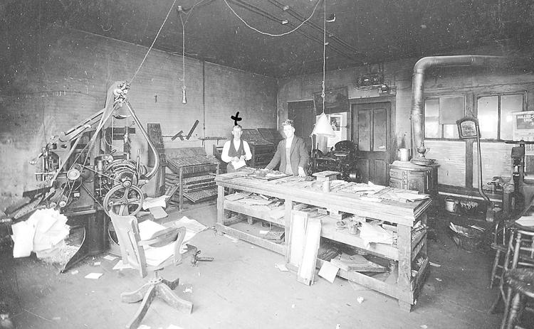 In the offices of the Table Rock Argus, circa 1921. Editor Frank Taylor is marked by an X, we don’t know the name of this assistant.