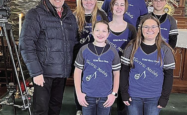 Jon Vanderford, left, of Pure Nebraska with the HTRS Show Choir in the Museum at Old St. John’s Catholic Church in Table Rock. Back row: Jake Manning. Middle Row: Alyssa Askren, teacher Katie Umland, and Brittyn Monarrez. Front row: Ellisyn Herr and Kendal Freeman.