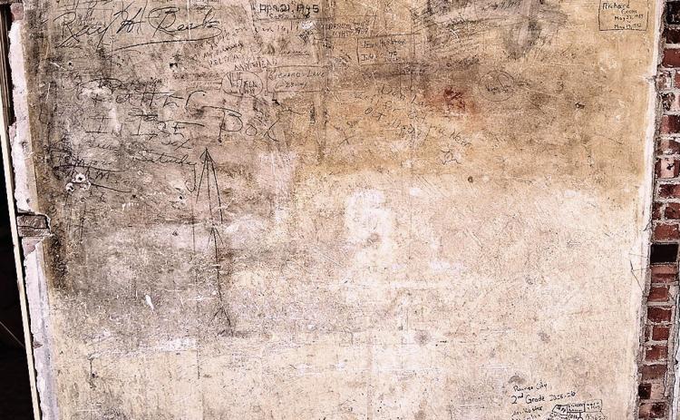 A full view of the back wall of Old Guys Brew where signatures dating back to the late ‘30s can be found
