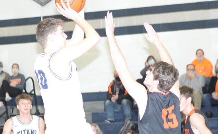 HTRS’ Trevor Plager (#10) goes up for a jumper against Falls City as teammate Jacob Joy (#24, left) looks on. Plager scored 8 points in the game. Paula Jasa/Republican