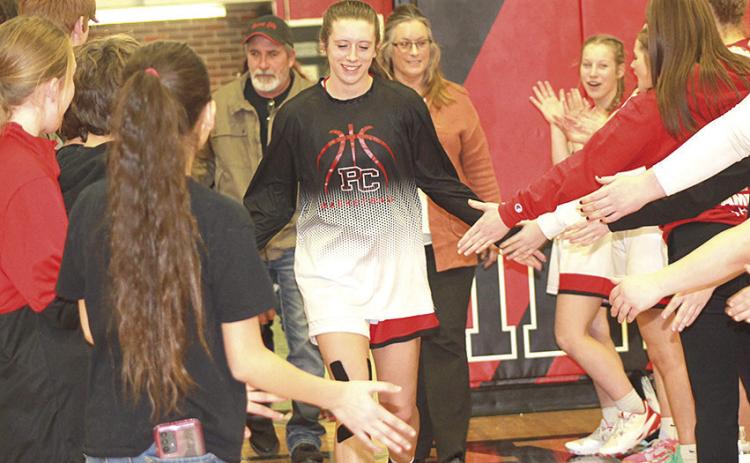 Paula Jasa/Republican P.C.’s Hallye Friedly runs through the tunnel of sportsmanship from all of the athletes who represented the Pawnee City Senior/Parent’s Night on Tuesday night in their game against Humboldt Table Rock Steinauer.