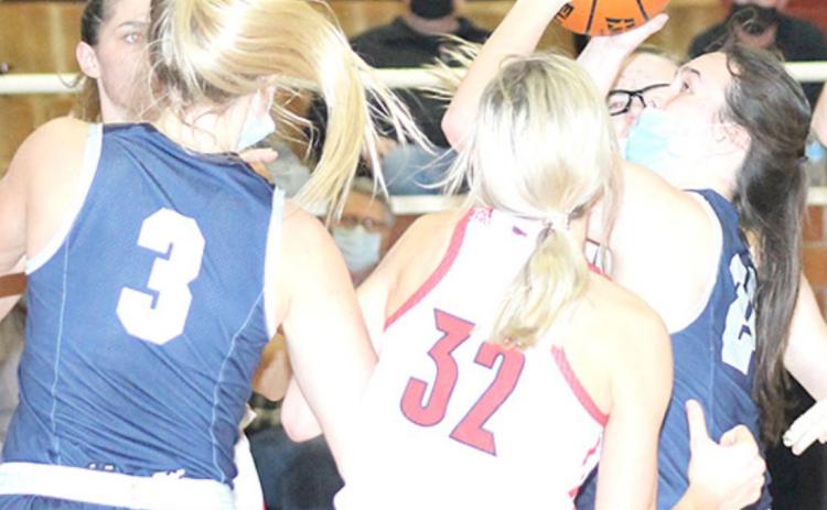 HTRS’ Tara Zimmerling (#24, right) puts up a shot against Wymore Southern as teammate Katilyn Glathar (#3, left) looks to help out or rebound. Paula Jasa/Republican