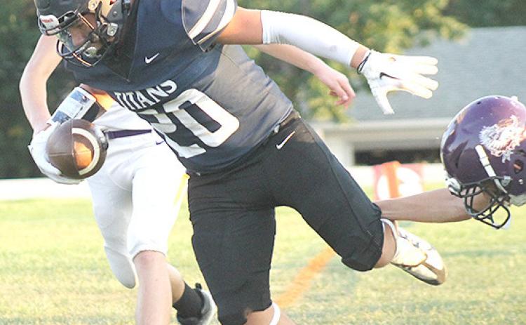 HTRS’ Alex Koziol (#20) scores on a touchdown early in the game for the Titans. Paula Jasa/Republican