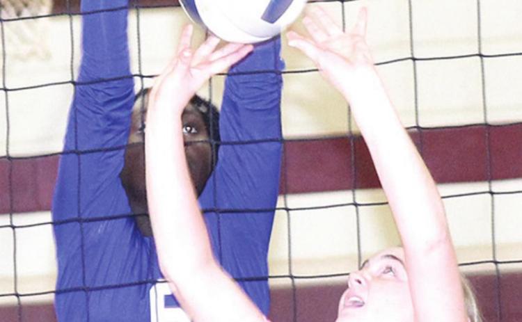 LHS’ Carleigh Weyers (#9, right) goes up for a tip/set at the net. Weyers had several tips at the net. Paula Jasa/Republican