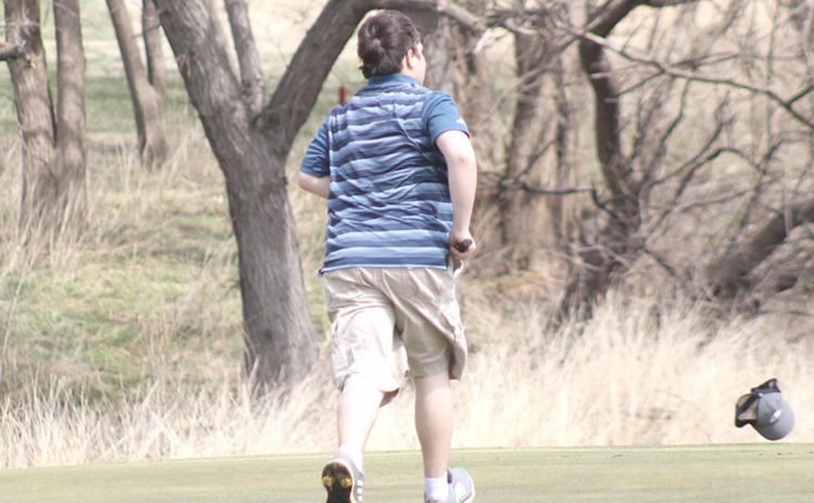 The gusty conditions at the HTRS Invite on Tuesday, April 12th wreaked havoc on the golfers as HTRS’ Carson Refsdal found out when he lost his hat on the #3 green. Paula Jasa/Republican