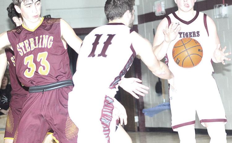 LHS’ Brady Bledsaw (#11, left) makes a perfect pass to teammate Caleb Rule (right for an easy bucket. Bledsaw led Lewiston with 24 points against Sterling. Paula Jasa/Republican
