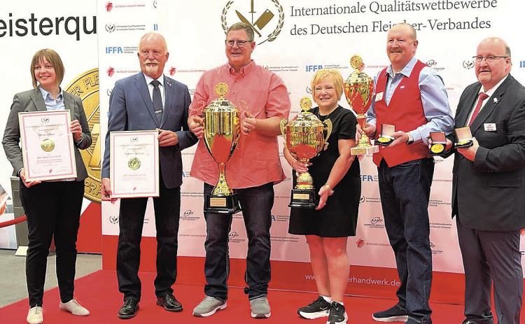 Dennis and Kim Schaardt (center) accept their awards from the German Butcher’s Association in Frankfurt Germany