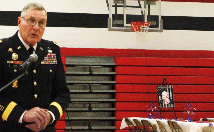 Photos submitted by Anne Veleba The guest speaker for the day was Ret. Major General Charles 'Jim' Barr from the US Army. In the background you can see tables set up for the luncheon that was prepared by Karen Blank and the kitchen staff and was served by Student Council members. Displayed on the easels are posters created by Mrs. Pierce's fifth grade class, paying tribute to friends and family members who have served in various branches of the military.
