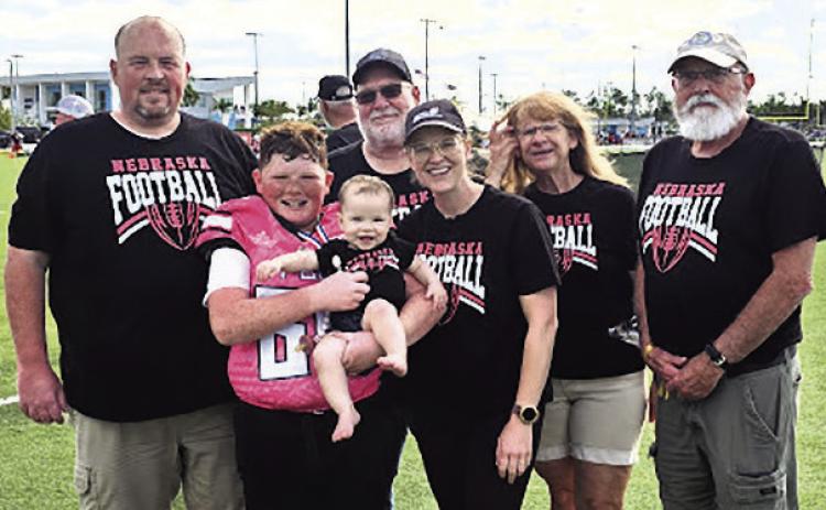 Left to right: Tanner Hatfield, Jackson Hatfield, Quinley Hatfield, Marvin Blecha, Dani Hatfield, Candy Blecha, and Charlie Hatfield pose for a family photo in Naples, Florida, during the Football University National Championships. Jackson, an 11-year-old fifth grader, competed as a member of the FBU Nebraska 10U All-Star Team.