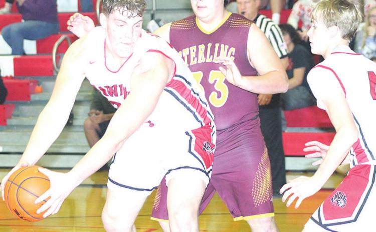 P.C.’s Simon Osborne (left) looks to make a move in the paint as teammate Kylenn Koester (#4, right) looks on. Osborne had several three-point plays in the game. Paula Jasa/Republican